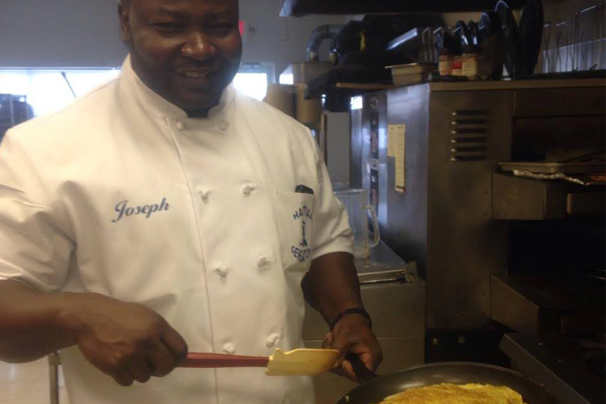 Joseph cooking at Haitian Sensation.